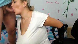  Big breasted webcam milf flaunts her curves and sucks a dick